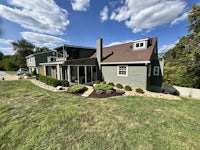 a home with a green lawn and trees